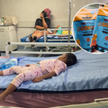 A young child sleeping on a hospital bed