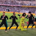 A young woman dressed like Tyla dancing with other dancers at the Moses Mabhida stadium