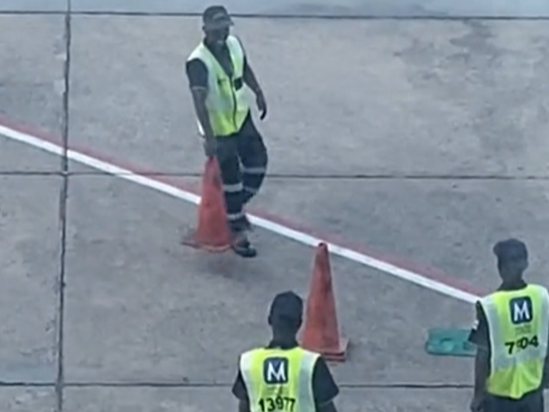 Airport staff playing with traffic cones on the airfield