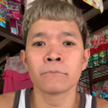 An Asian man glues his lips stuck