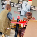 An elderly couple eating at a KFC restaurant