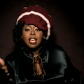 Angie Stone wearing a white and maroon beanie