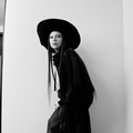 Lady Gaga wearing a black hat and dress