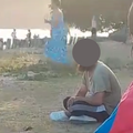 A man with a beard stares at a family at the beach