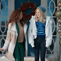 Brandy and her co-star standing in front of house for Christmas