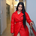 Cardi B wearing a long red leather coat