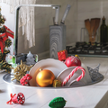 Christmas toys and unwashed dishes inside the kitchen sink