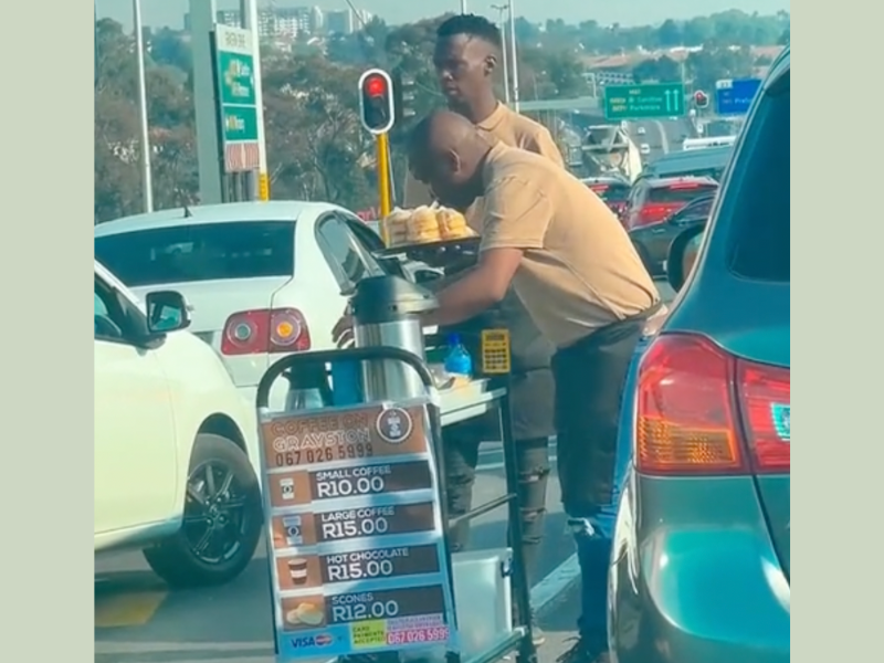 Man sells coffee at traffic light