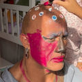 Dwayne Johnson has makeup all over his face while playing with daughters