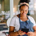 Happy female entrepreneur smiling while holding a digital tablet