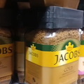 Jacob Kronung coffee jars on shelf with security tags
