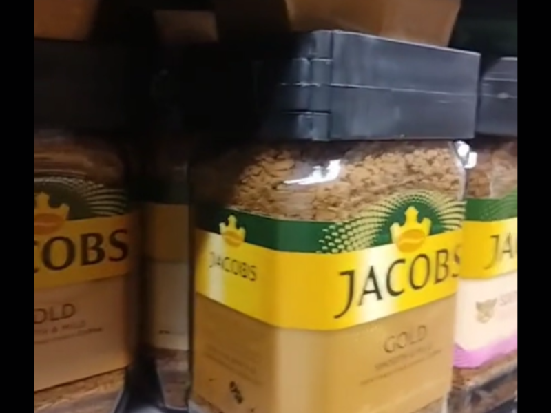 Jacob Kronung coffee jars on shelf with security tags
