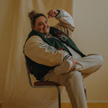 JAMIE FINE SITTING ON CHAIR