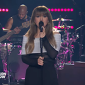 Kelly Clarkson wearing an off the shoulder dress