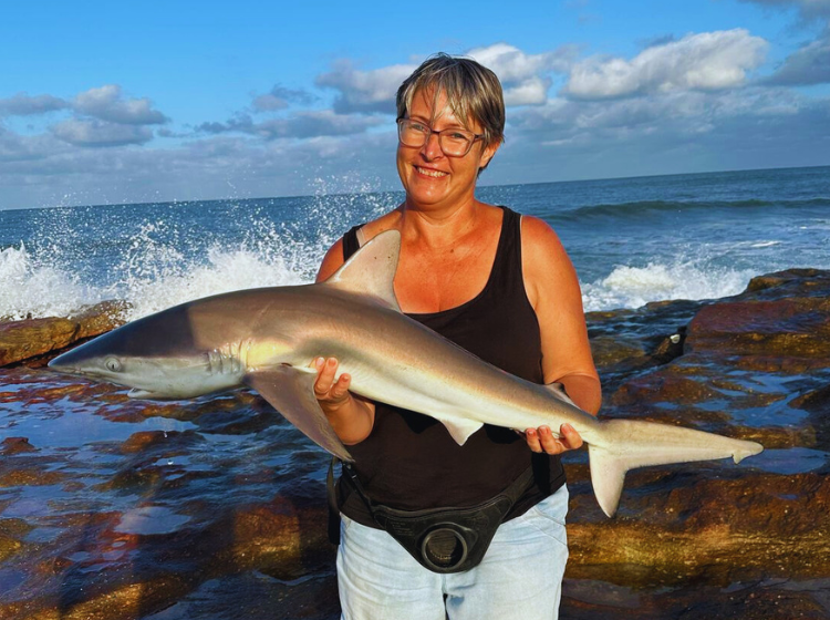 Lalanie Theron holds onto the non-edible action with a grey shark caught down south
