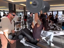 Lenny Kravitz pumping iron wearing leather pants
