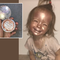 Little girl covered in glitter shimmer powder