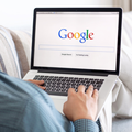 Man sitting on the MacBook on Google search engine