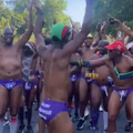 Men dressed in purple speedos running a race