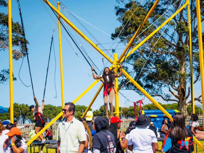 People enjoying themselves outdoors at a picnic and jump trampoline activity