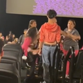 People inside movie theatre fighting