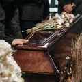 Person holding a wooden coffin