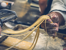 Person making pasta tagliatelle