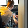 Pilots looking at a phone while sitting in the cockpit