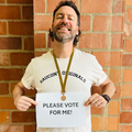 Rory Petzer posing with a please vote for me sign