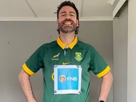 Rory Petzer wearing a Springbok t shirt with an FNB sign