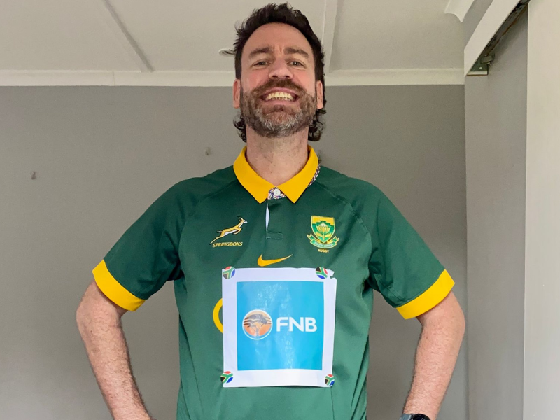 Rory Petzer wearing a Springbok t shirt with an FNB sign