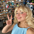Sabrina Carpenter holding up a peace sign