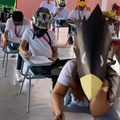 Students wearing funny hats while writing their examinations