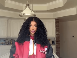 SZA poses in a kitchen