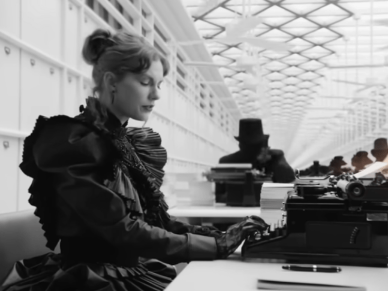 Taylor Swift typing on a typewriter