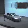 The COO and President at Sony Honda Mobility standing on stage with electric vehicle