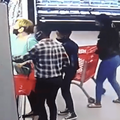 Three people wearing masks crowd a woman at the supermarket stealing her phone