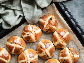 Traditional hot cross buns on a baking tray