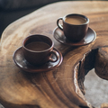 Two brown ceramic mugs