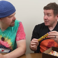 Two men sitting a table discussing snacks from South Africa