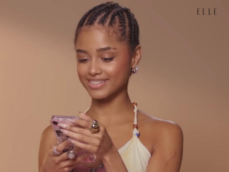 Tyla checking her phone