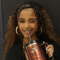 Tyla winks while sipping on a tiger-themed Stanley Cup