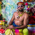 Vic Naidoo dressed up in eccentric costumes chatting about his mental health