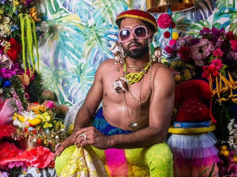 Vic Naidoo dressed up in eccentric costumes chatting about his mental health