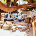 View of people at a Farmers market exchanging goods for money