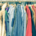 Vintage second hand clothes on shop rack at flea market