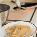 Woman preparing crepes on a pan