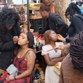 Women get their makeup done on the roadside of Johannesburg street