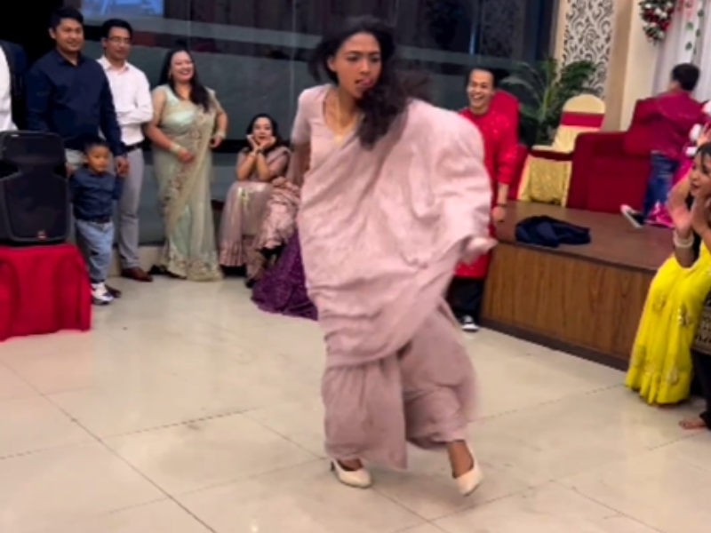 Young woman wearing saree dancing